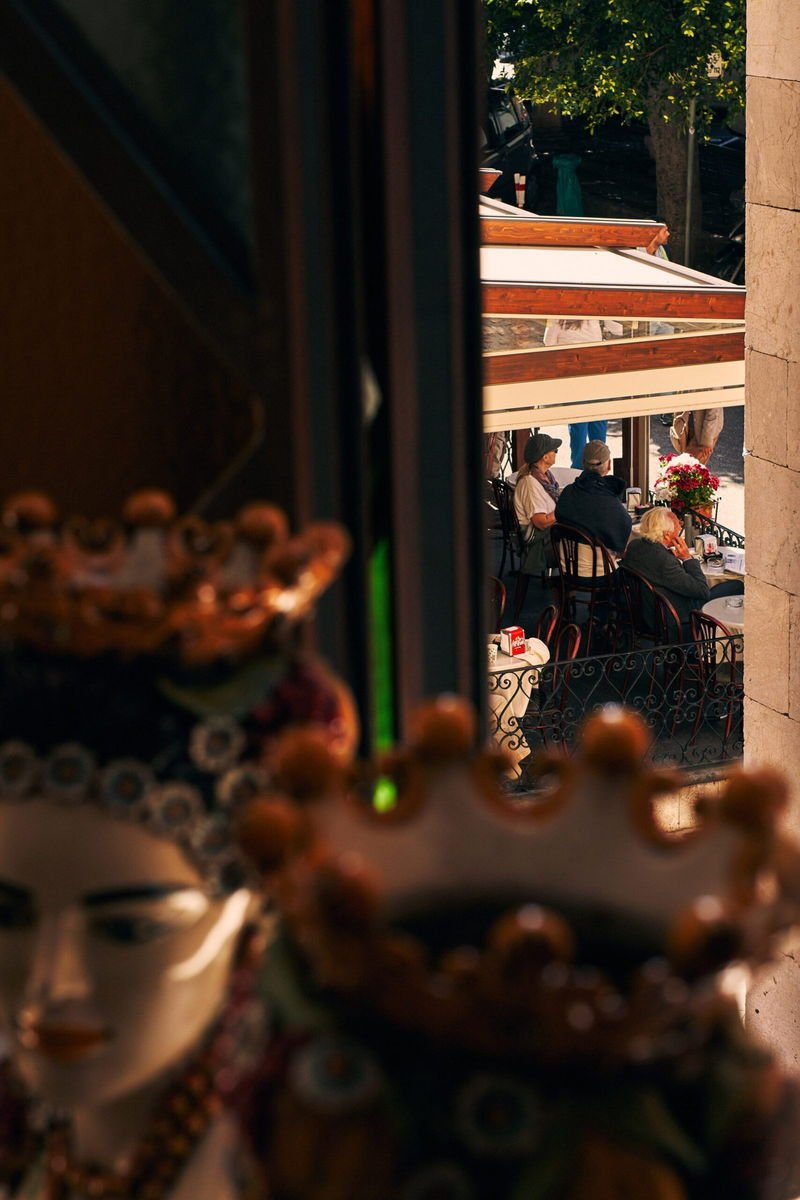 A pavement café in Taormina seen past Sicilian ceramics