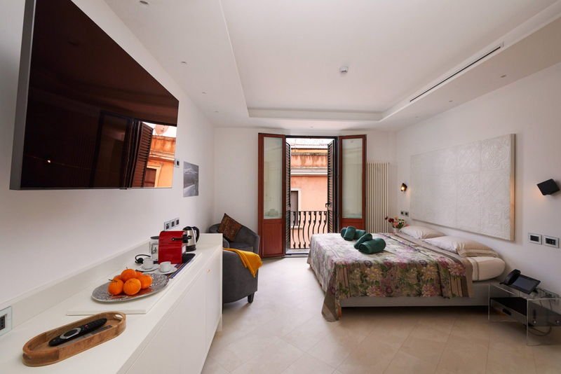 The suite seen from the doorway, with a large flat-screen television