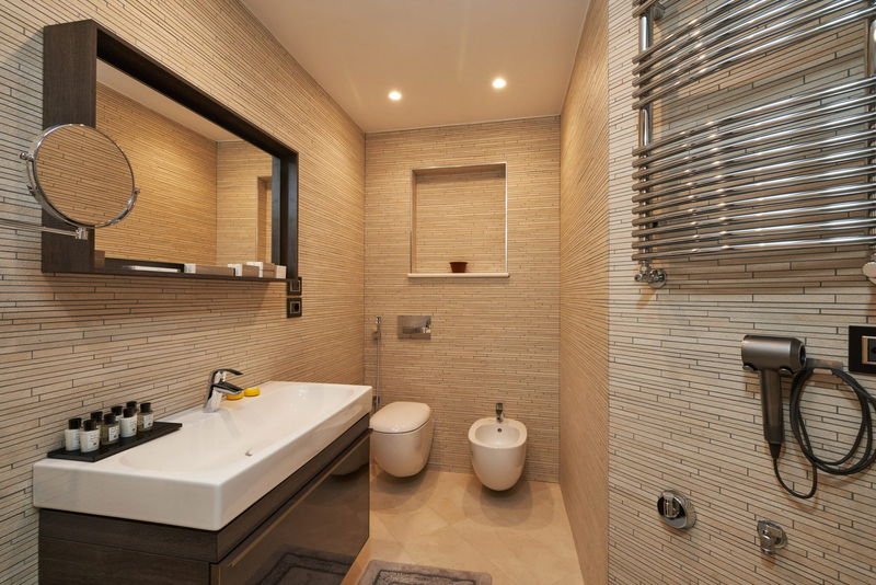 Deluxe Suite bathroom clad in fine travertine mosaic