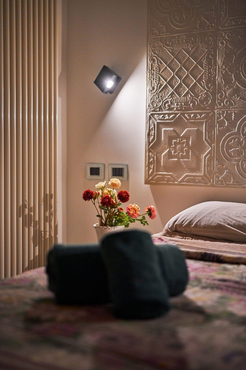 Corner of the Deluxe Suite with fresh flowers on a side table