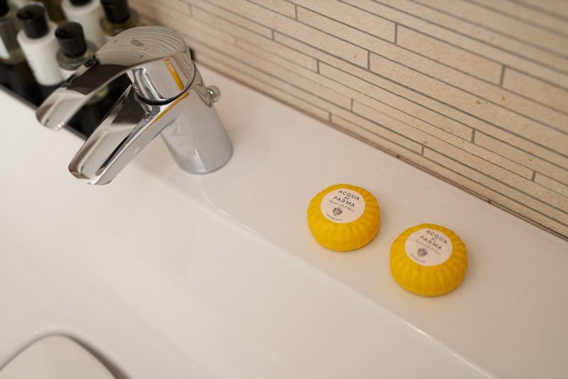 Two Acqua di Parma soaps beside the basin