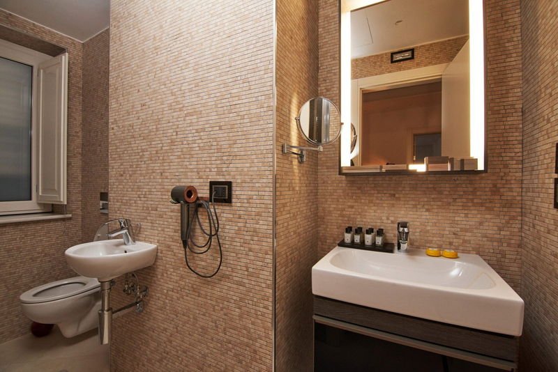 Queen Standard bathroom with backlit mirror and mosaic walls